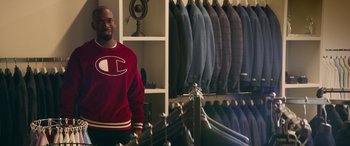 Movie still from “All My Life” (2020), directed by Marc Meyers – A man standing in front of a rack of jackets; Medium shot, Over the shoulder angle
