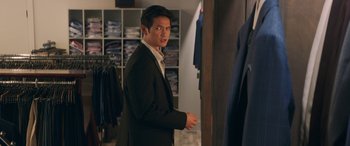 Movie still from “All My Life” (2020), directed by Marc Meyers – A man in a suit looking in the mirror; Medium shot, Over the shoulder angle