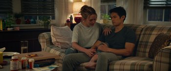 Movie still from “All My Life” (2020), directed by Marc Meyers – A man and a woman sitting on a couch together; Medium shot, High angle