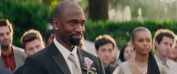 Movie still from “All My Life” (2020), directed by Marc Meyers – A man in a suit and tie with a flower in his lapel; Close Up shot, Over the shoulder angle