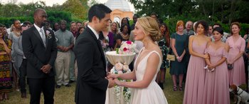 Movie still from “All My Life” (2020), directed by Marc Meyers – A man and a woman holding hands in front of a crowd of onlookers; Medium shot, Over the shoulder angle