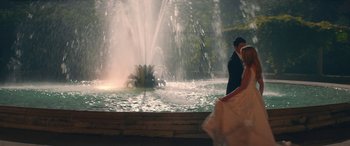Movie still from “All My Life” (2020), directed by Marc Meyers – A man and a woman standing in front of a fountain; Wide shot, Over the shoulder angle