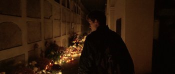 A man standing in front of a bunch of candles