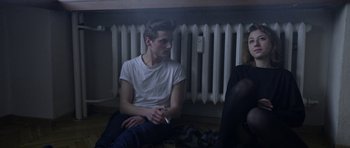 A man and a woman sitting next to each other on the floor