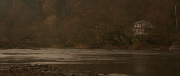 Movie still from “All the Real Girls” (2003), directed by David Gordon Green – A body of water surrounded by a forest of trees; Extreme Wide shot, High angle