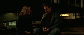 Movie still from “All the Real Girls” (2003), directed by David Gordon Green – A man and a woman sitting next to each other in the dark; Medium shot, Over the shoulder angle