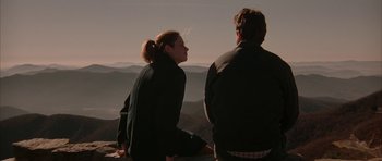 Movie still from “All the Real Girls” (2003), directed by David Gordon Green – A man and a woman sitting on top of a mountain; Medium shot, Over the shoulder angle