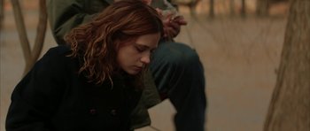 Movie still from “All the Real Girls” (2003), directed by David Gordon Green – A woman sitting on the ground with her eyes closed; Close Up shot, Low angle