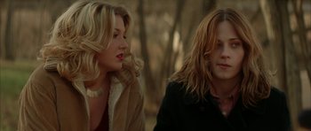 Movie still from “All the Real Girls” (2003), directed by David Gordon Green – Two women sitting next to each other in a park; Medium shot, Over the shoulder angle