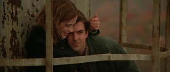 Movie still from “All the Real Girls” (2003), directed by David Gordon Green – A man and a woman leaning against a fence; Medium shot, Low angle