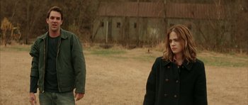 Movie still from “All the Real Girls” (2003), directed by David Gordon Green – Two people standing in a field near a barn; Medium shot, Low angle
