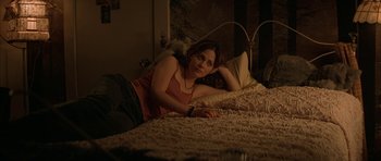 Movie still from “All the Real Girls” (2003), directed by David Gordon Green – A woman laying on a bed in a room; Medium shot, High angle