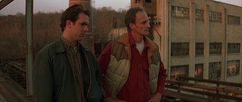 Movie still from “All the Real Girls” (2003), directed by David Gordon Green – Two men standing next to each other on a street; Medium shot, Over the shoulder angle
