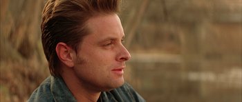 Movie still from “All the Real Girls” (2003), directed by David Gordon Green – A person looking to his left; Close Up shot, Over the shoulder angle