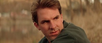 Movie still from “All the Real Girls” (2003), directed by David Gordon Green – A person wearing a green jacket; Close Up shot, Low angle