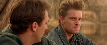 Movie still from “All the Real Girls” (2003), directed by David Gordon Green – Two men are looking at one another in the mirror; Close Up shot, Over the shoulder angle