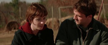 Movie still from “All the Real Girls” (2003), directed by David Gordon Green – A man and a woman are standing next to each other; Close Up shot, Over the shoulder angle