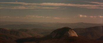 Movie still from “All the Real Girls” (2003), directed by David Gordon Green – A view of a mountain range from a distance; Extreme Wide shot, High angle