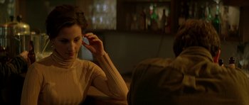 Movie still from “All the Real Girls” (2003), directed by David Gordon Green – A woman sitting in front of a man on a phone; Close Up shot, Over the shoulder angle