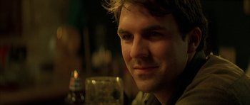 Movie still from “All the Real Girls” (2003), directed by David Gordon Green – A person with a drink in front of him; Close Up shot, Over the shoulder angle