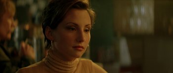 Movie still from “All the Real Girls” (2003), directed by David Gordon Green – A person with short hair wearing a sweater; Close Up shot, Over the shoulder angle