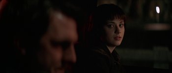 Movie still from “All the Real Girls” (2003), directed by David Gordon Green – A young woman sitting next to a man in a dark room; Close Up shot, Over the shoulder angle