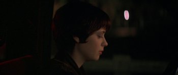 Movie still from “All the Real Girls” (2003), directed by David Gordon Green – A woman with short brown hair looking to the side; Close Up shot, Over the shoulder angle