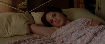 Movie still from “All the Real Girls” (2003), directed by David Gordon Green – A woman laying in a bed with her head on a pillow; Close Up shot, High angle