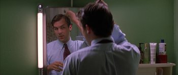 Movie still from “All the Real Girls” (2003), directed by David Gordon Green – A man is looking at himself in the mirror; Close Up shot, Over the shoulder angle