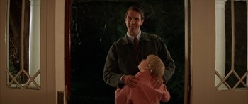 Movie still from “All the Real Girls” (2003), directed by David Gordon Green – A man and a little girl standing next to each other; Medium shot, Over the shoulder angle