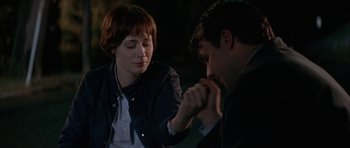 Movie still from “All the Real Girls” (2003), directed by David Gordon Green – A man and a woman holding hands in a dark room; Close Up shot, Over the shoulder angle