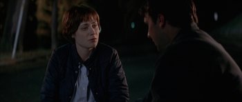 Movie still from “All the Real Girls” (2003), directed by David Gordon Green – A woman sitting next to a man in a dark room; Close Up shot, Over the shoulder angle
