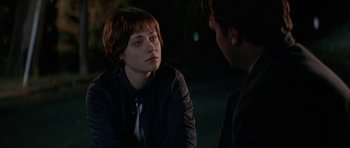 Movie still from “All the Real Girls” (2003), directed by David Gordon Green – A woman sitting next to a man in a dark room; Close Up shot, Over the shoulder angle
