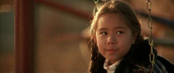 Movie still from “All the Real Girls” (2003), directed by David Gordon Green – A little girl is looking into the camera; Close Up shot, Over the shoulder angle