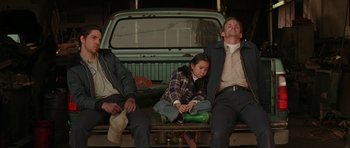 Movie still from “All the Real Girls” (2003), directed by David Gordon Green – A group of people sitting in the back of a pick up truck; Medium shot, Low angle