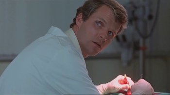 Movie still from “Alligator” (1980), directed by Lewis Teague – A person holding a pencil; Close Up shot, Low angle