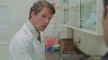 Movie still from “Alligator” (1980), directed by Lewis Teague – A man wearing a lab coat in front of a sink; Close Up shot, Low angle
