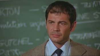 Movie still from “Alligator” (1980), directed by Lewis Teague – A person wearing a suit and tie; Close Up shot, Low angle