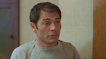 Movie still from “Alligator” (1980), directed by Lewis Teague – A person wearing a gray shirt; Close Up shot, Low angle