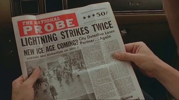Movie still from “Alligator” (1980), directed by Lewis Teague – A person holding a newspaper in their hand; Close Up shot, High angle