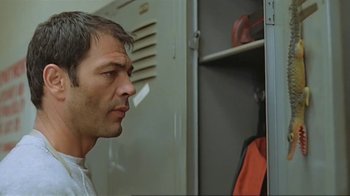 Movie still from “Alligator” (1980), directed by Lewis Teague – A person standing in front of an open locker; Close Up shot, Low angle