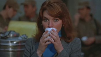 Movie still from “Alligator” (1980), directed by Lewis Teague – A person drinking a cup of coffee; Close Up shot, Over the shoulder angle