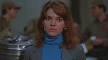 Movie still from “Alligator” (1980), directed by Lewis Teague – A person with long hair; Close Up shot, Low angle