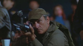 Movie still from “Alligator” (1980), directed by Lewis Teague – A person holding a camera; Close Up shot, Low angle