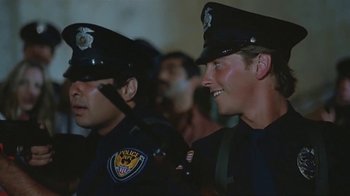 Movie still from “Alligator” (1980), directed by Lewis Teague – A couple of men in police uniforms standing next to each other; Close Up shot, Low angle