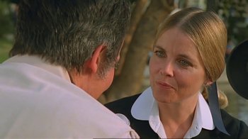 Movie still from “Alligator” (1980), directed by Lewis Teague – A man and a woman talking to each other; Close Up shot, Over the shoulder angle