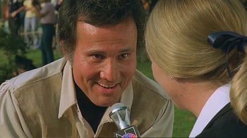 Movie still from “Alligator” (1980), directed by Lewis Teague – A person talking to a person holding a microphone; Close Up shot, Low angle