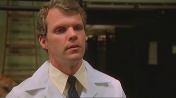 Movie still from “Alligator” (1980), directed by Lewis Teague – A person wearing a lab coat; Close Up shot, Low angle