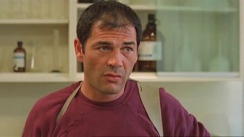 Movie still from “Alligator” (1980), directed by Lewis Teague – A person wearing a red shirt; Close Up shot, Low angle