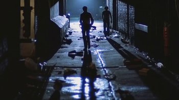 Movie still from “Alligator” (1980), directed by Lewis Teague – Two people walking down a dark alley at night; Wide shot, Low angle